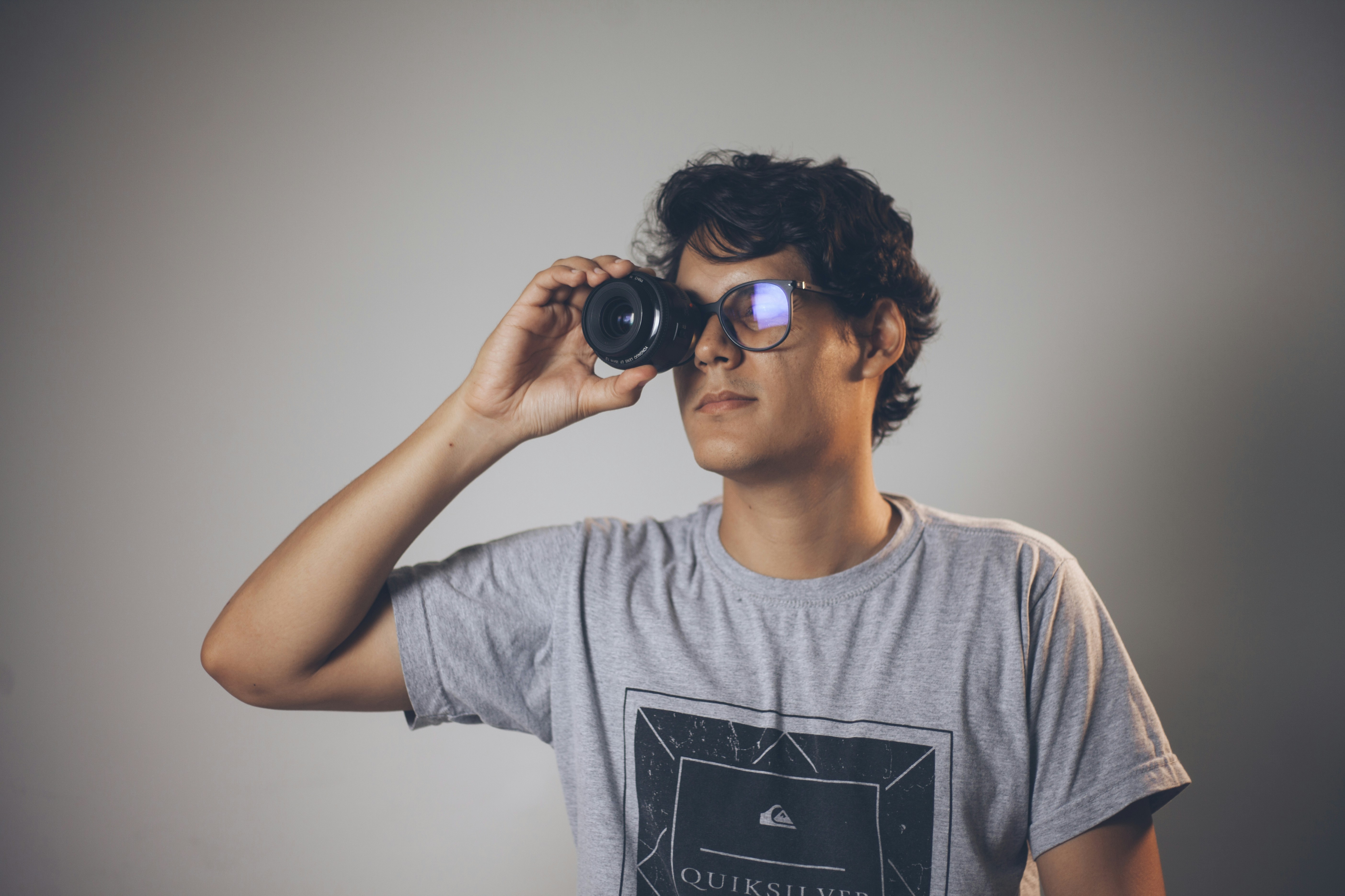 a young man is looking through binoculars