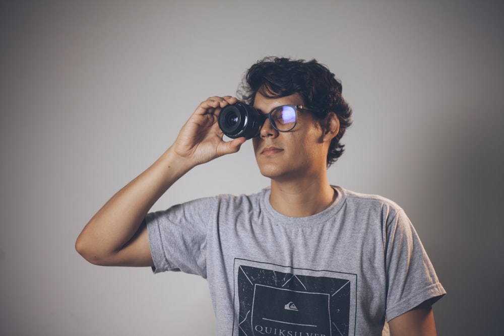 a young man is looking through binoculars