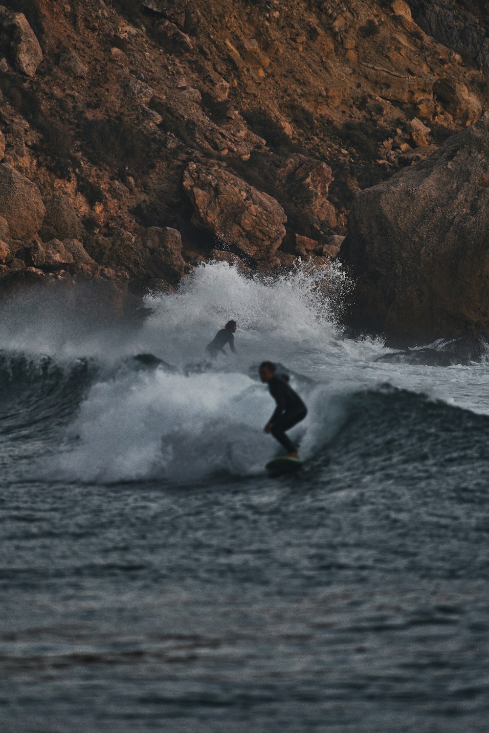 a man riding a wave on top of a surfboard