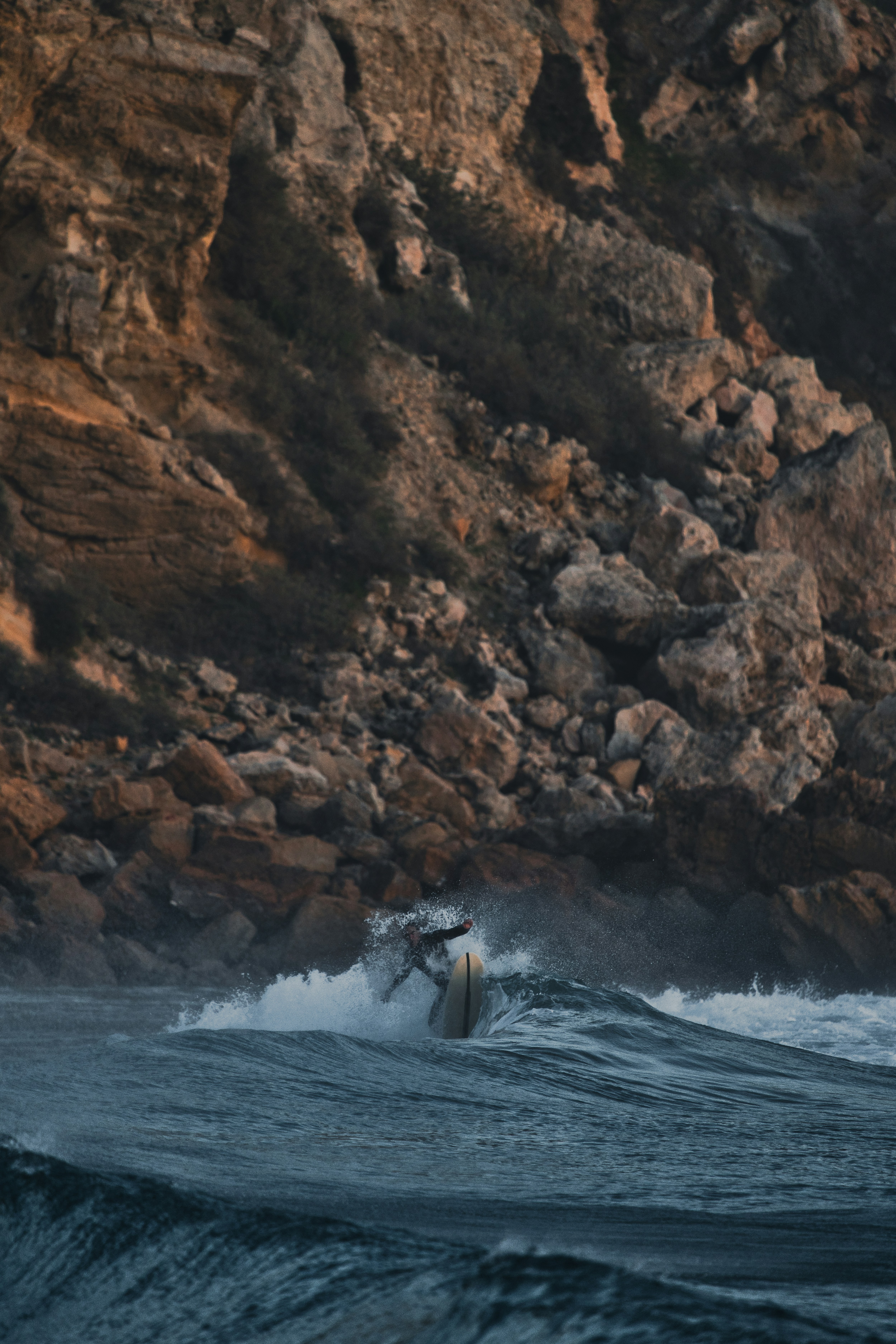 a man riding a wave on top of a surfboard