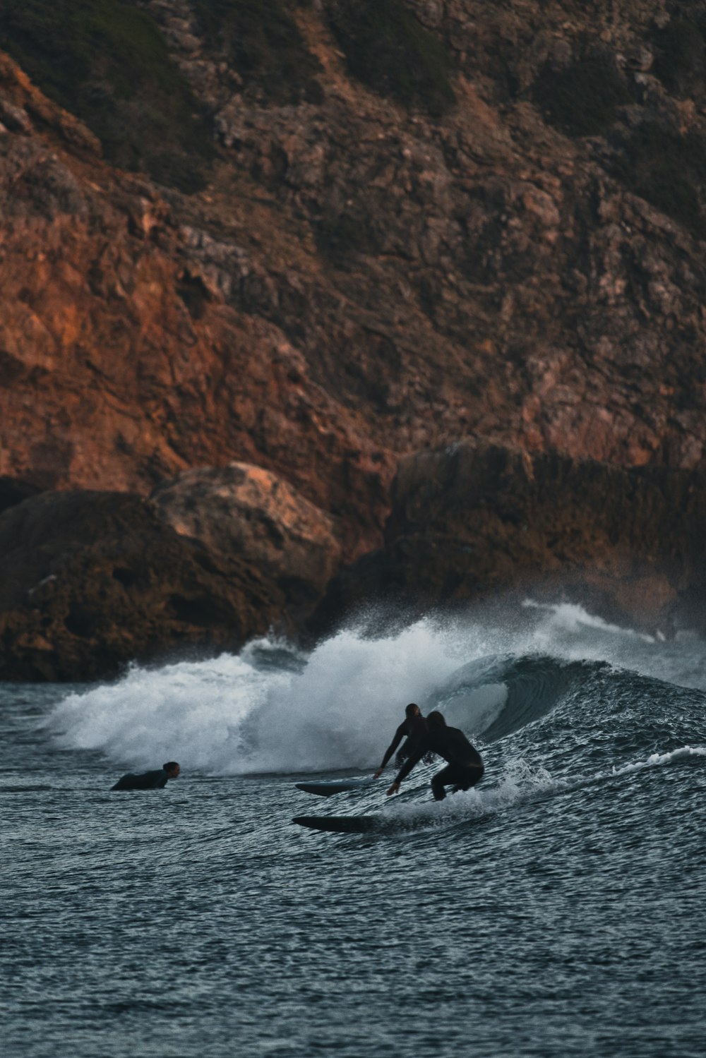 a man riding a wave on top of a surfboard