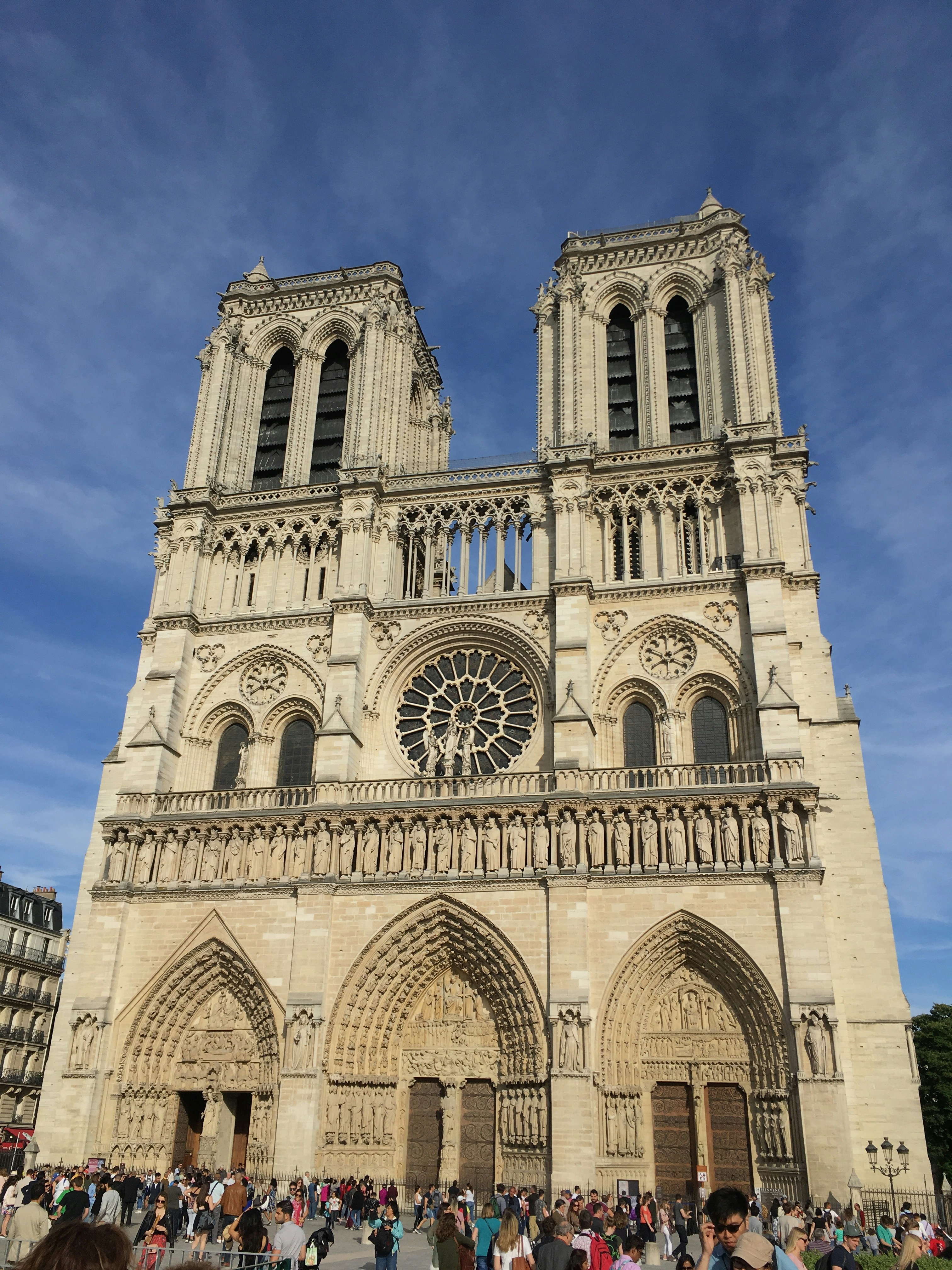 a group of people standing in front of a large cathedral