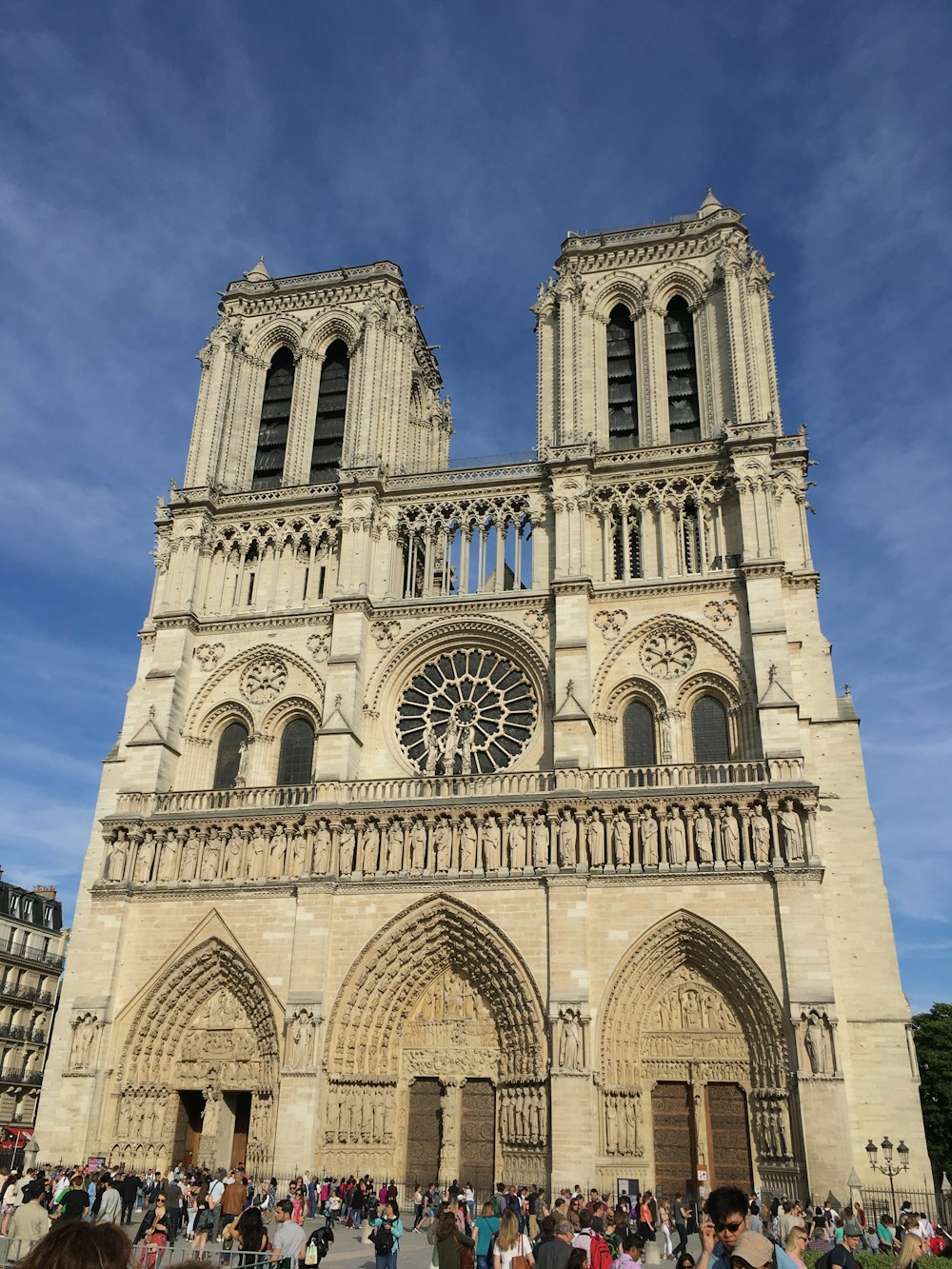 a group of people standing in front of a large cathedral