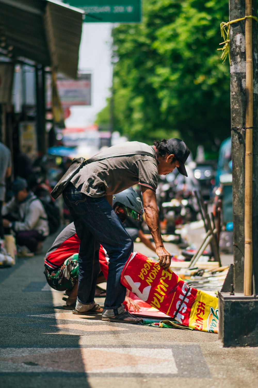 a man leaning over to pick up a bag of chips