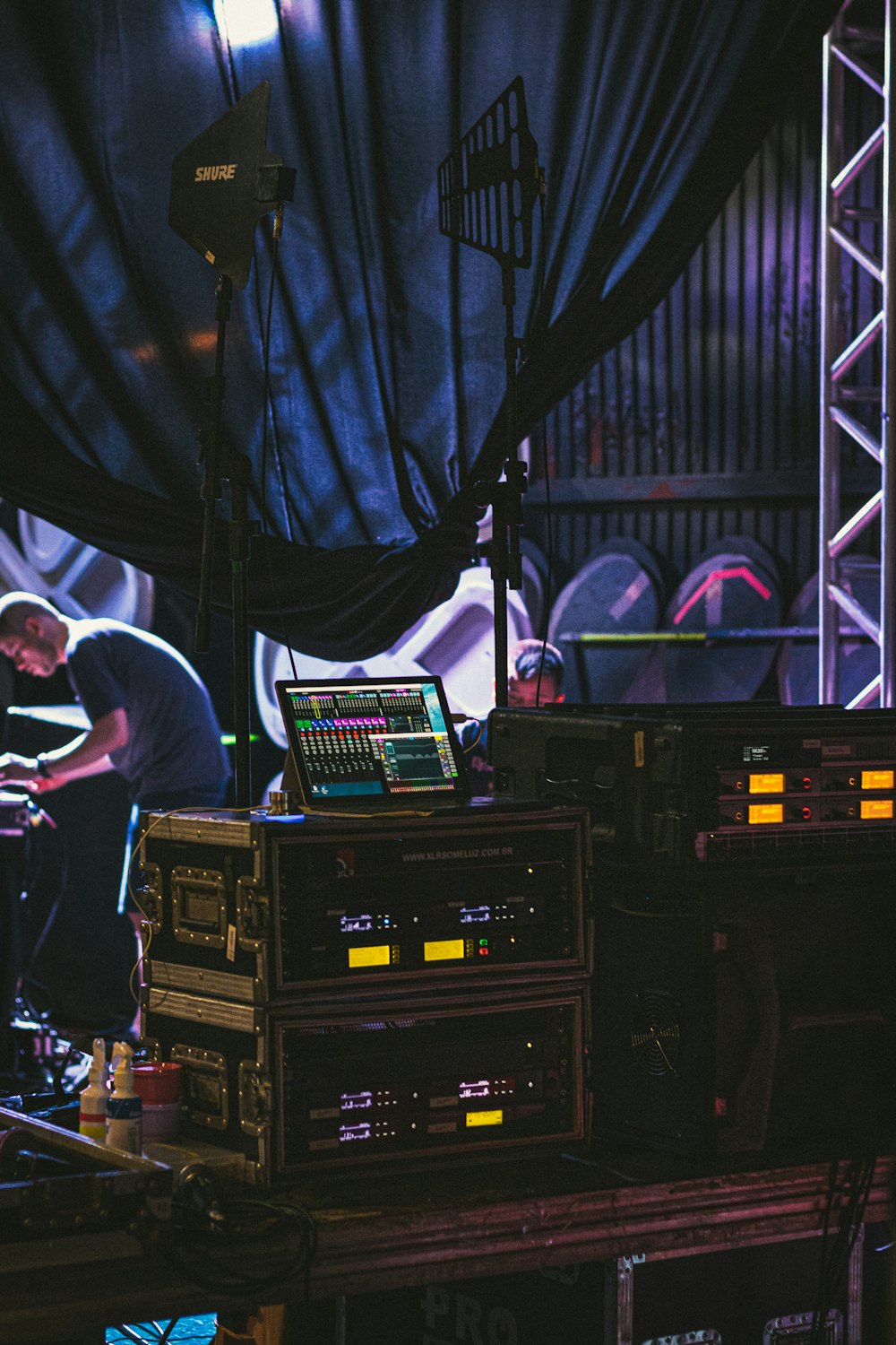 a man standing next to a bunch of sound equipment