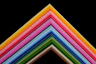 a group of multicolored papers stacked on top of each other