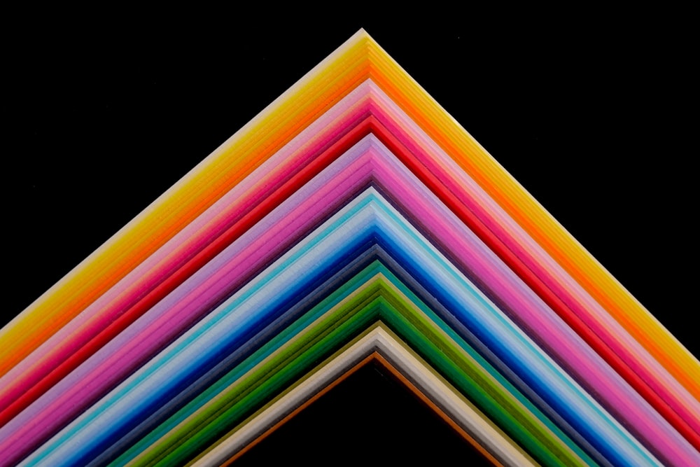 um grupo de papéis multicoloridos empilhados uns sobre os outros