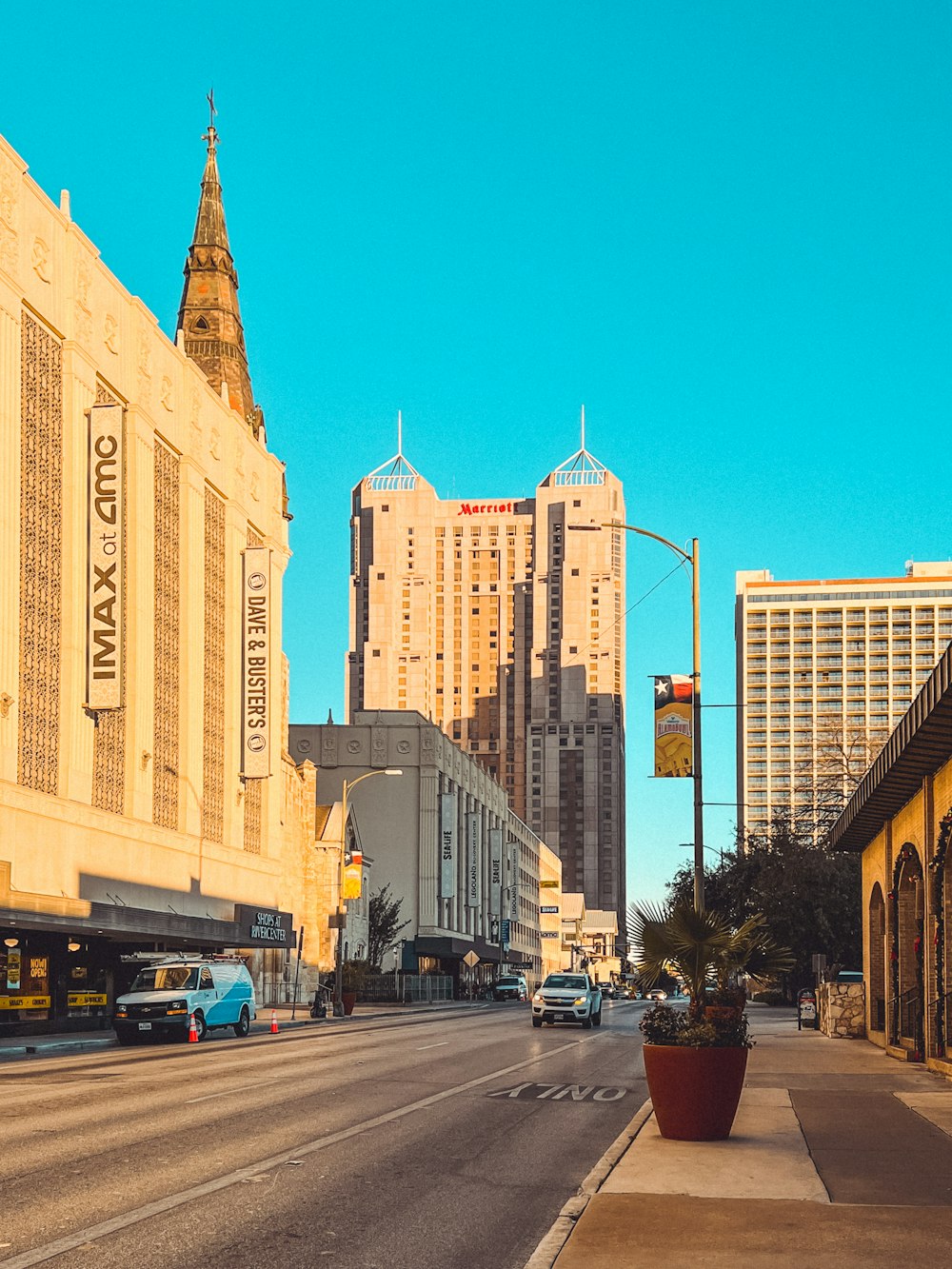 a city street with tall buildings in the background