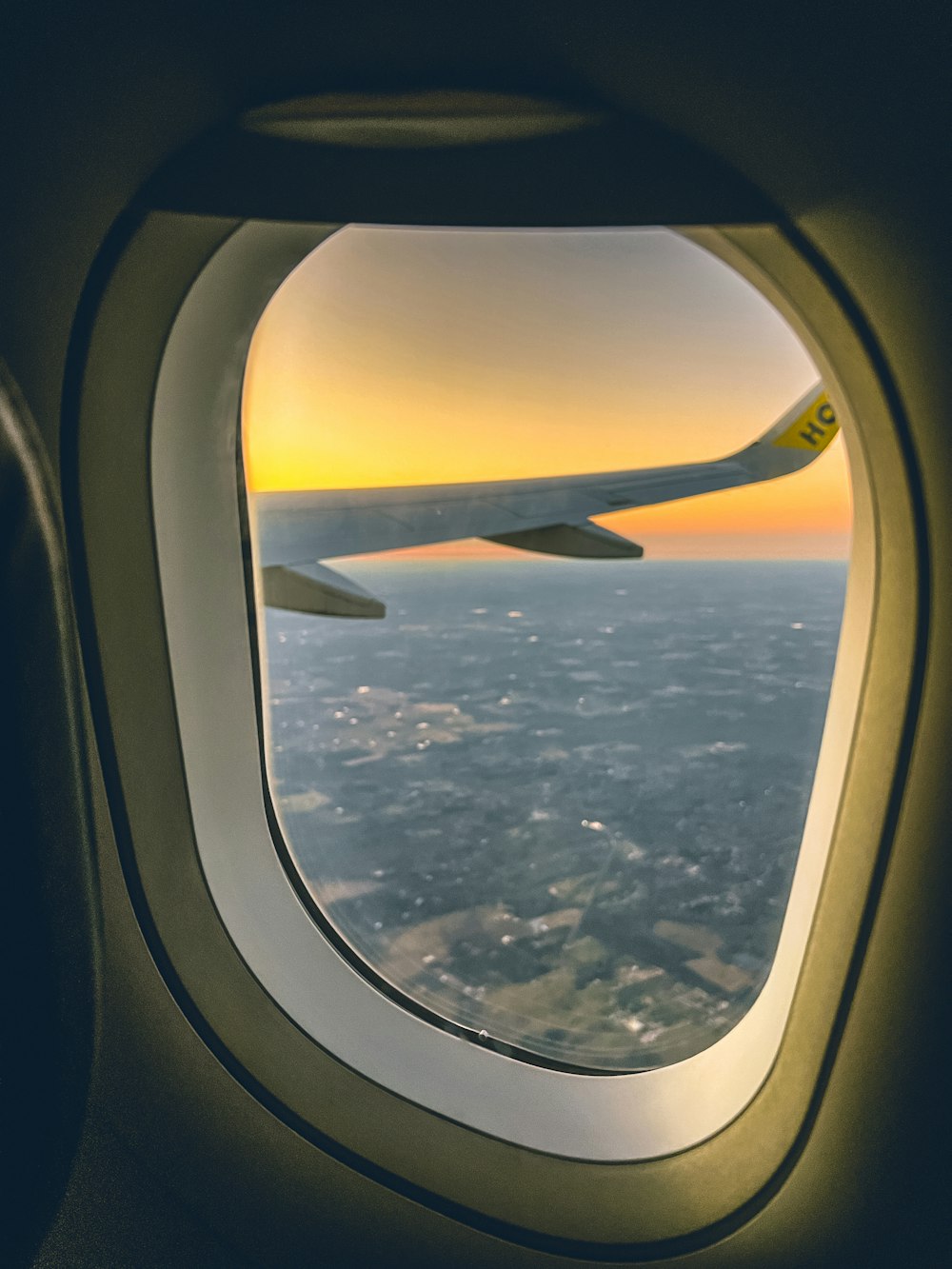 an airplane window with a view of the ocean