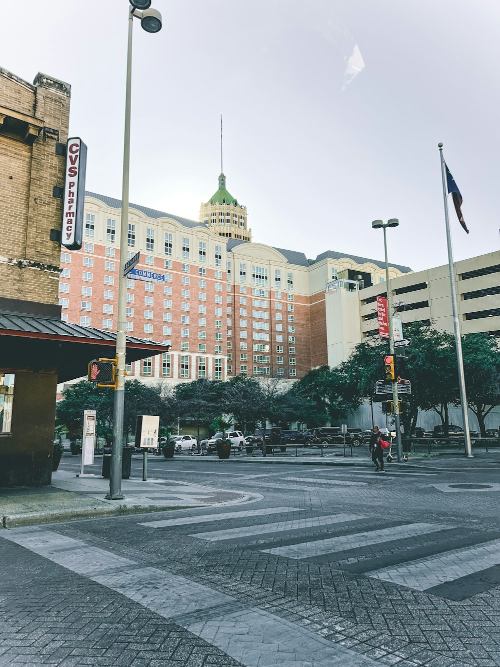 a city street with a tall building in the background