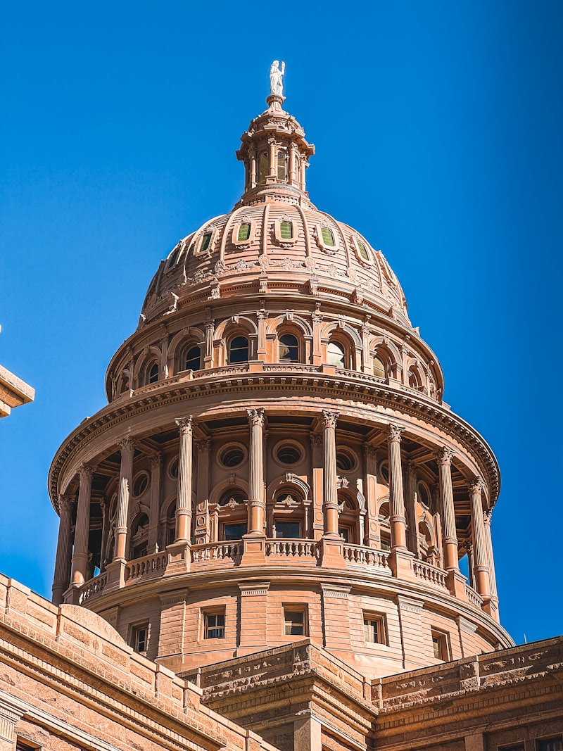 Dome of a state capitol building with a statue on top