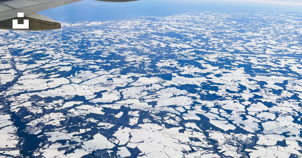 A view of the wing of an airplane flying over ice floes photo – Free ...