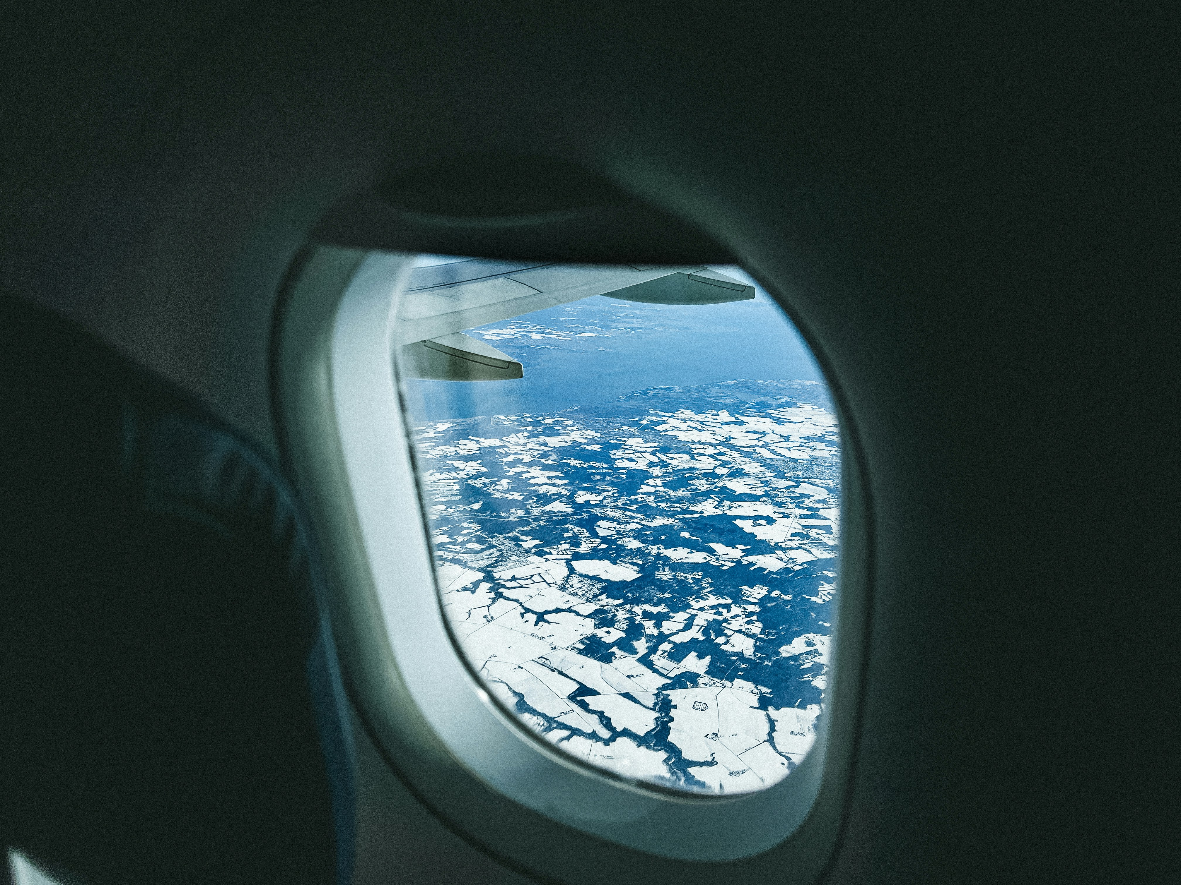 a view of the wing of an airplane looking out the window