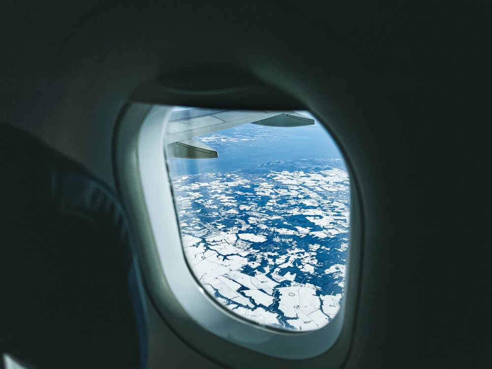 a view of the wing of an airplane looking out the window