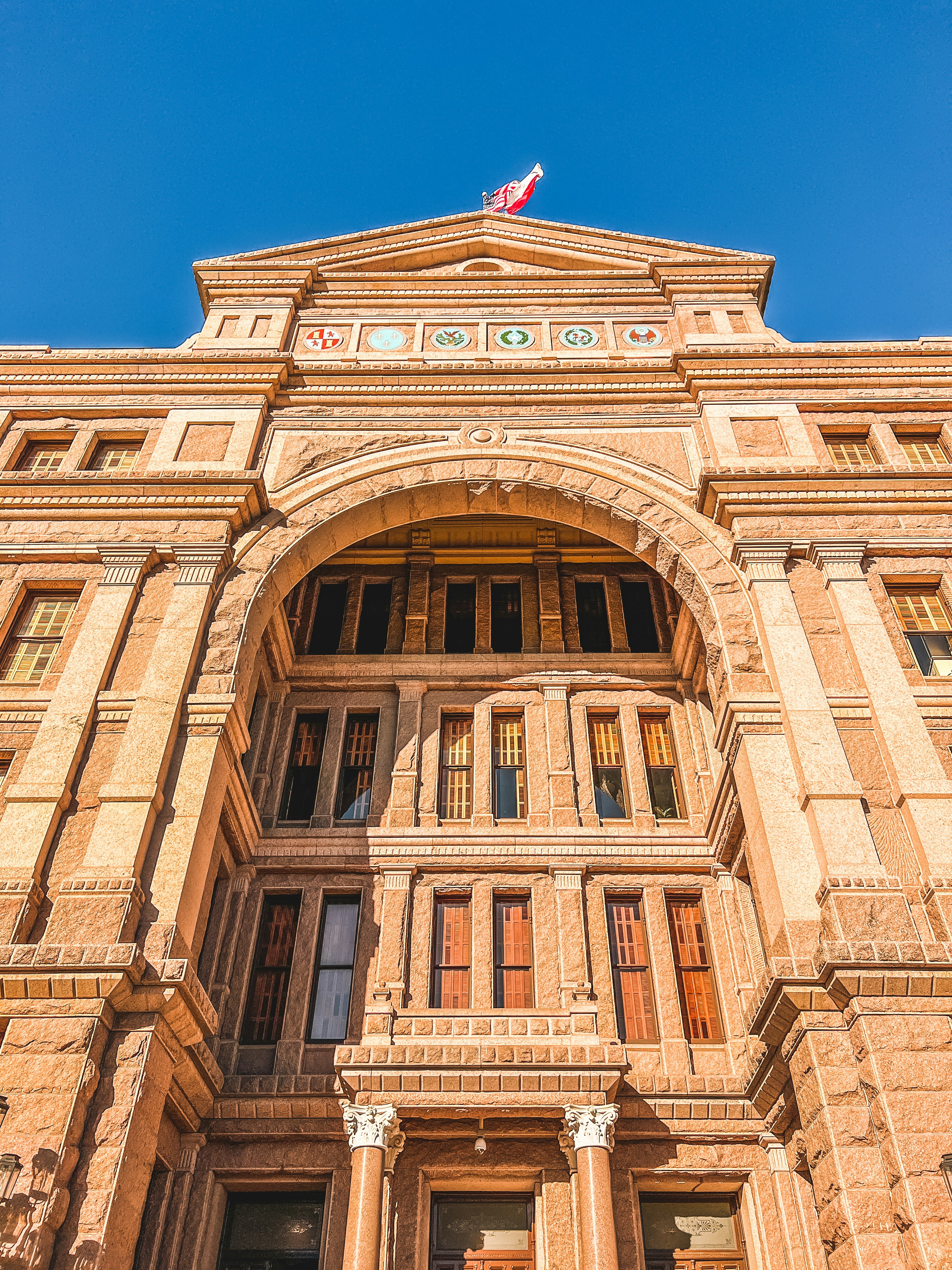 a tall building with a flag on top of it