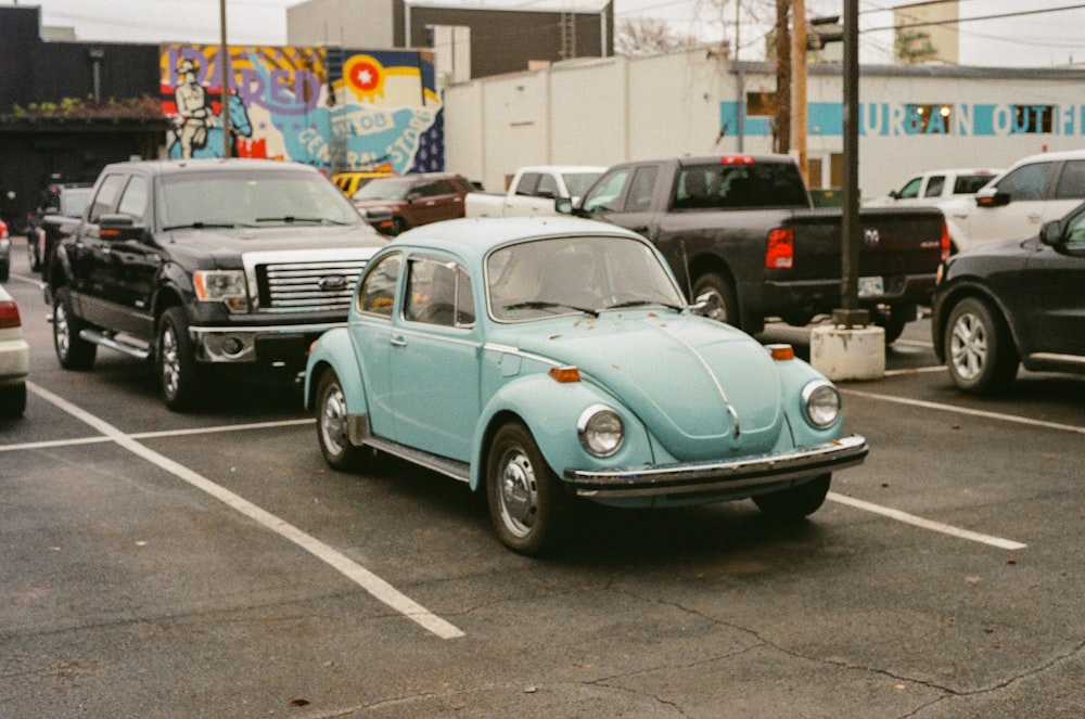 a blue beetle is parked in a parking lot
