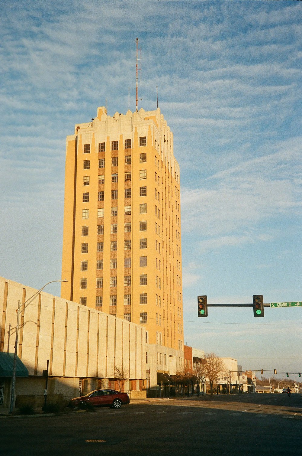 a traffic light sitting in front of a tall building