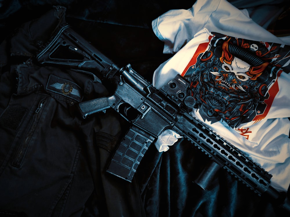 a gun with a skull on it laying on a black cloth