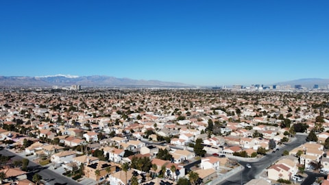 an aerial view of a city with mountains in the background