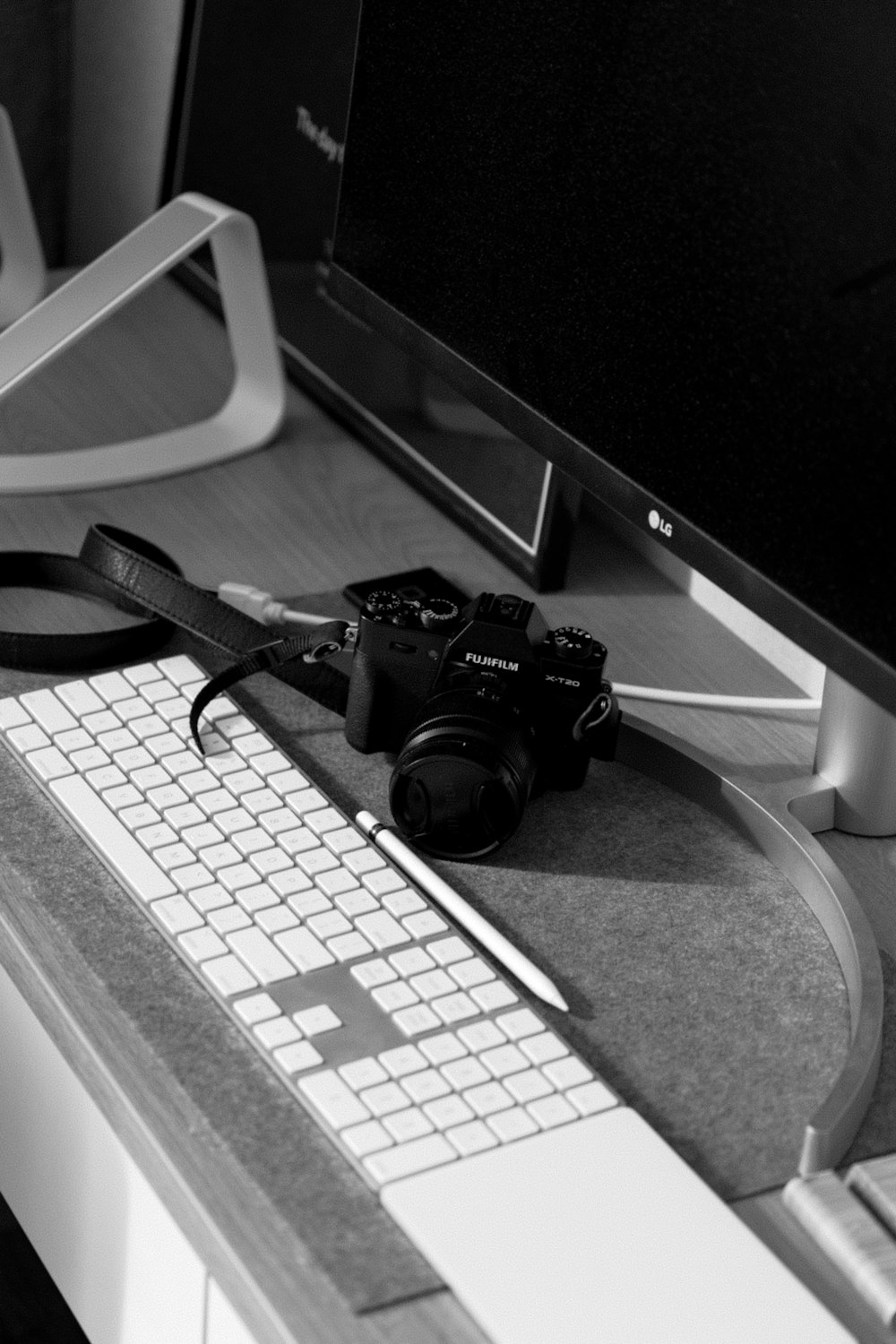 a black and white photo of a computer and a camera