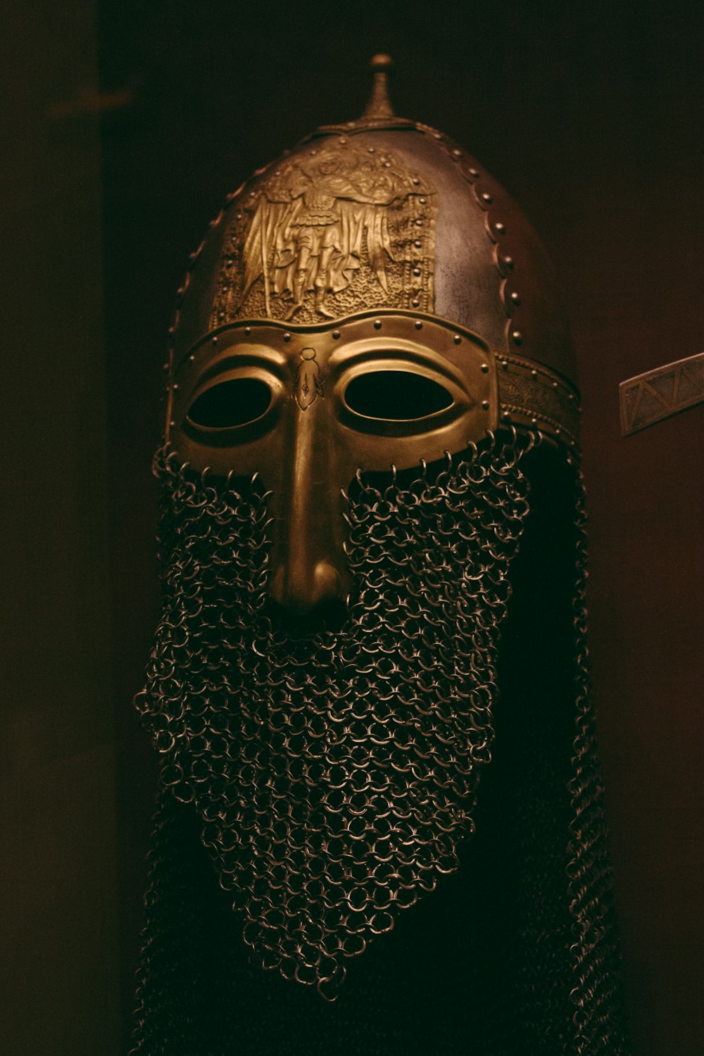 a bronze helmet with chains and a chain around it