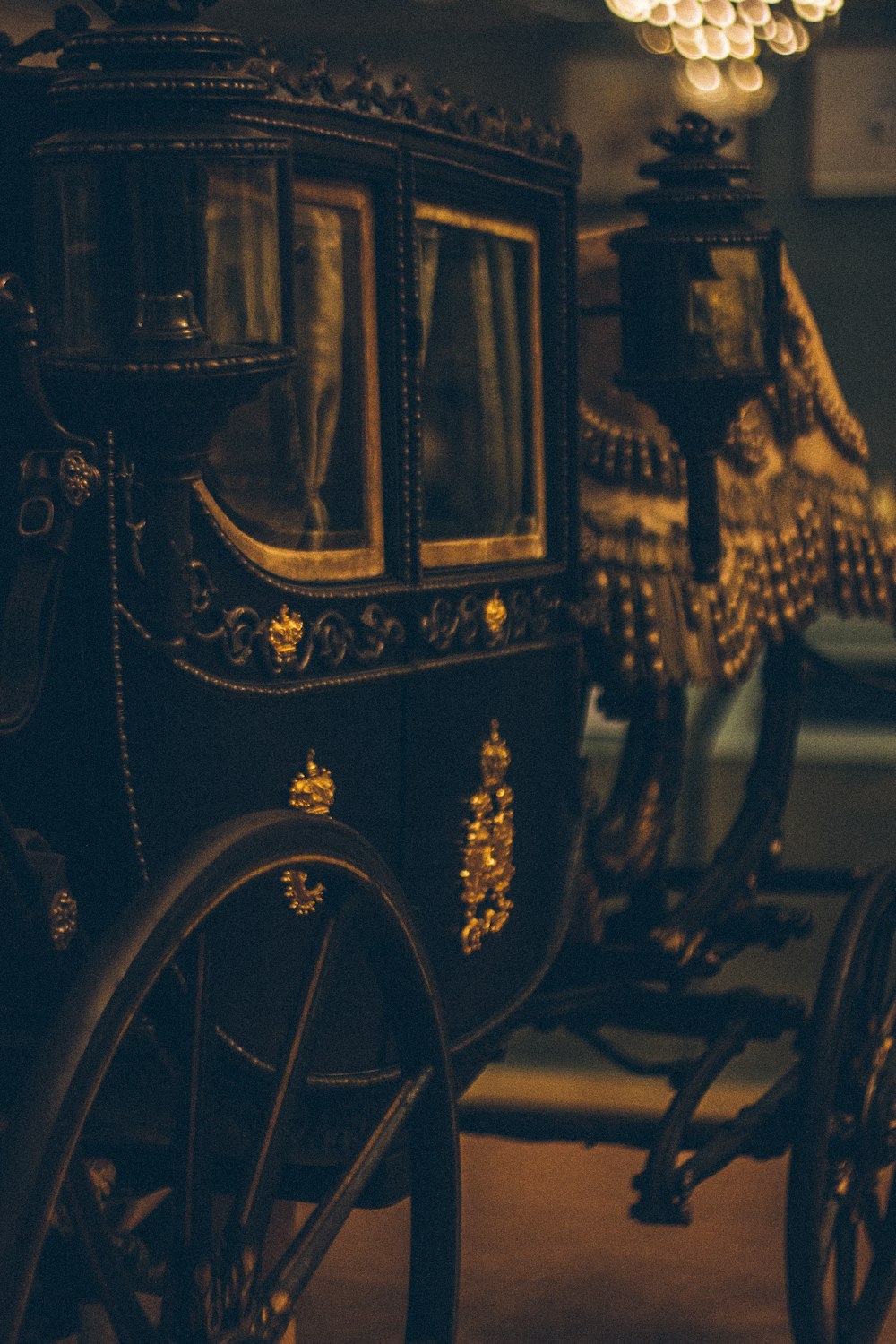 a horse drawn carriage in a room with a chandelier