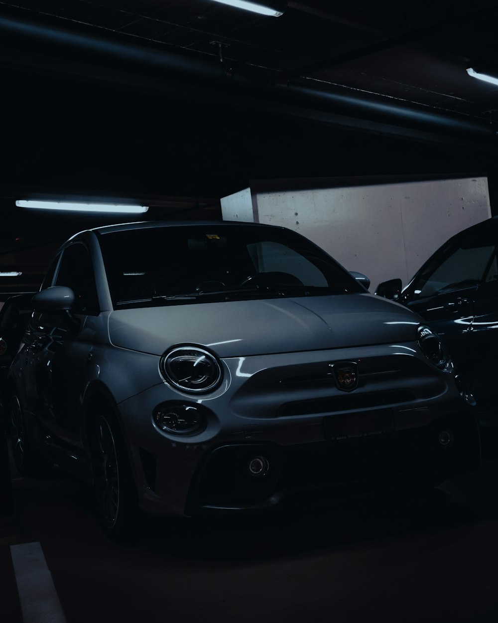 a couple of cars parked in a parking garage