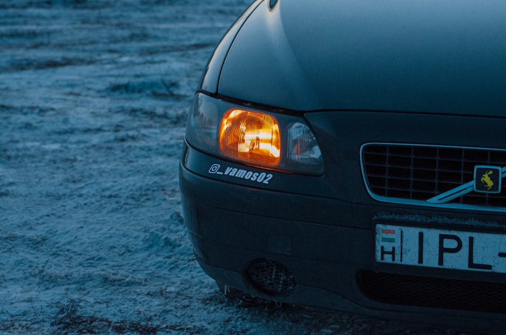 a close up of a car parked in the snow