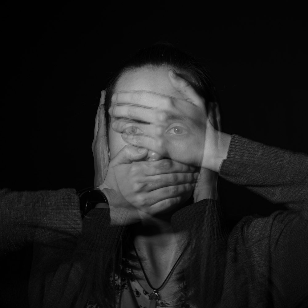 a woman covering her eyes with her hands