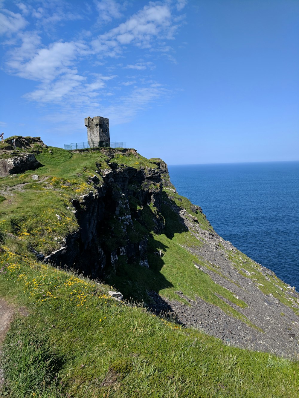 a grassy hill with a tower on top of it