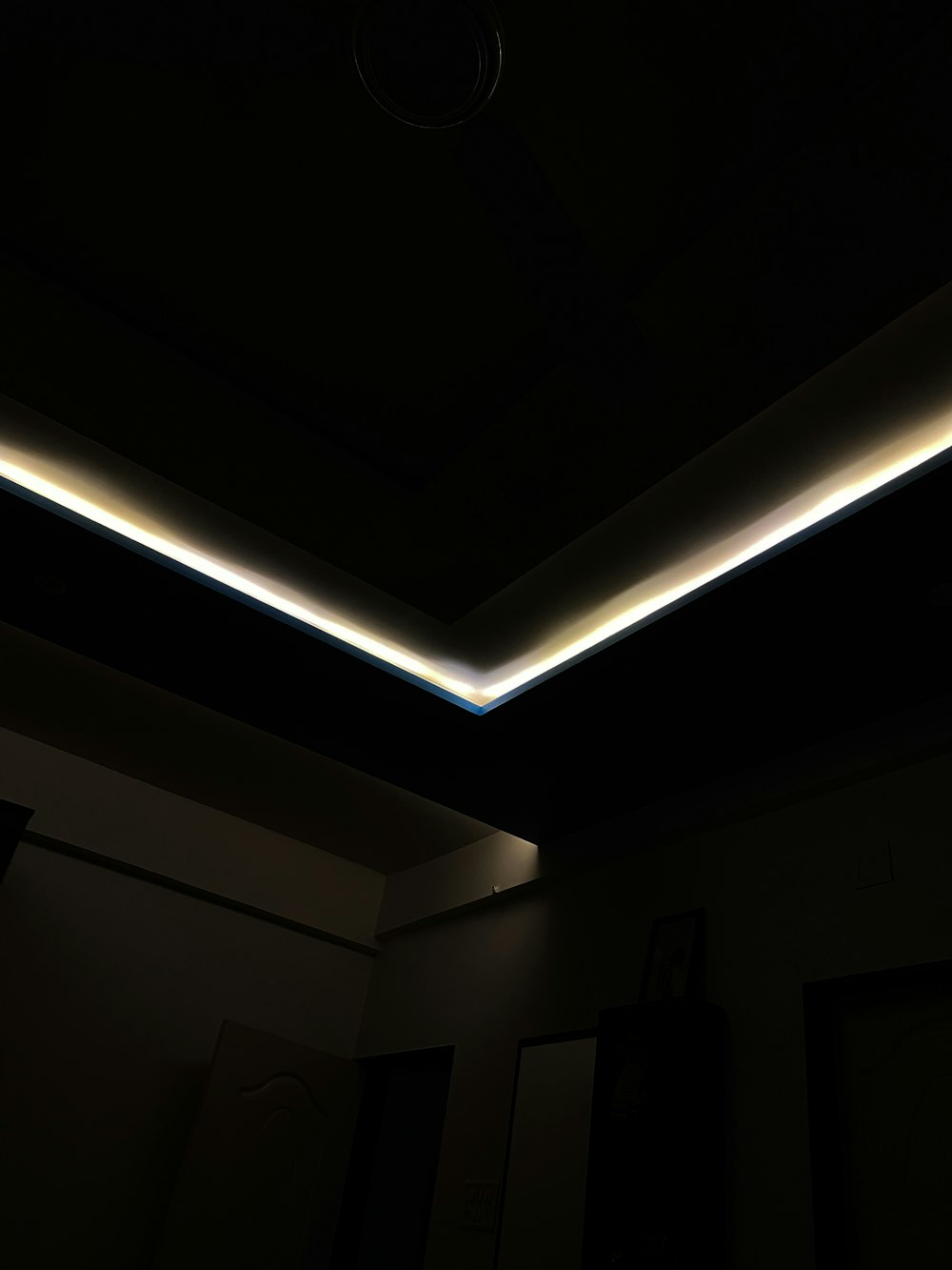 a dark room with a light on the ceiling