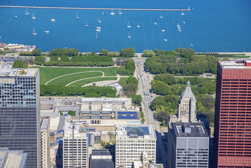 an aerial view of a city with boats in the water