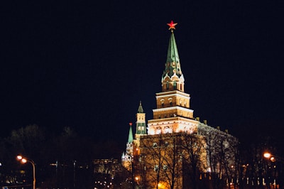 a large building with a steeple lit up at night