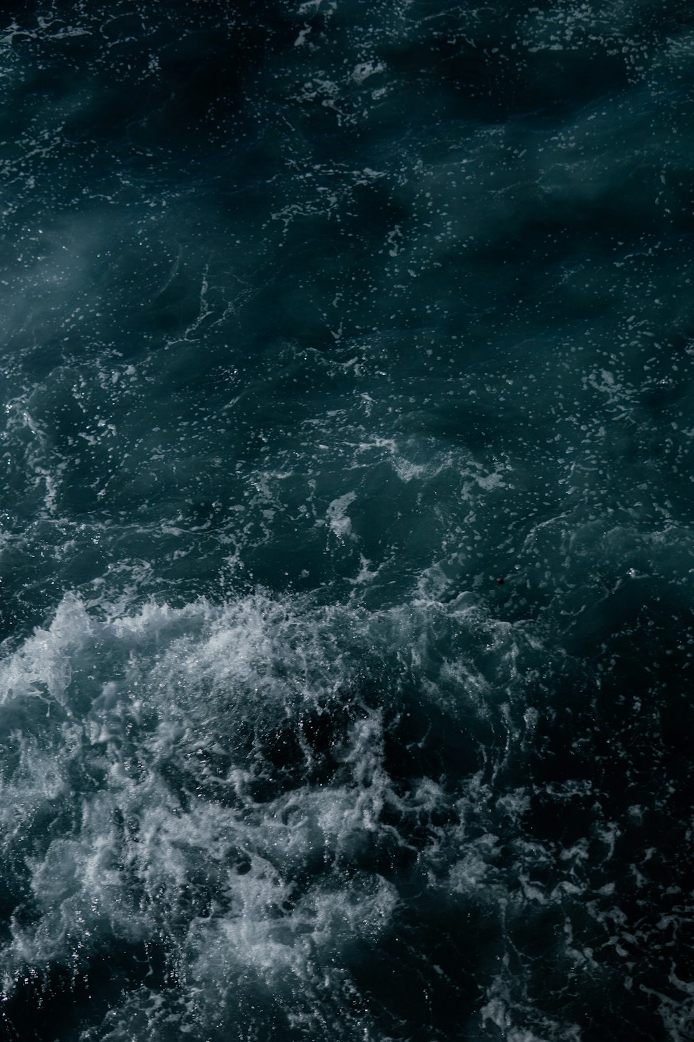 a man riding a surfboard on top of a wave in the ocean