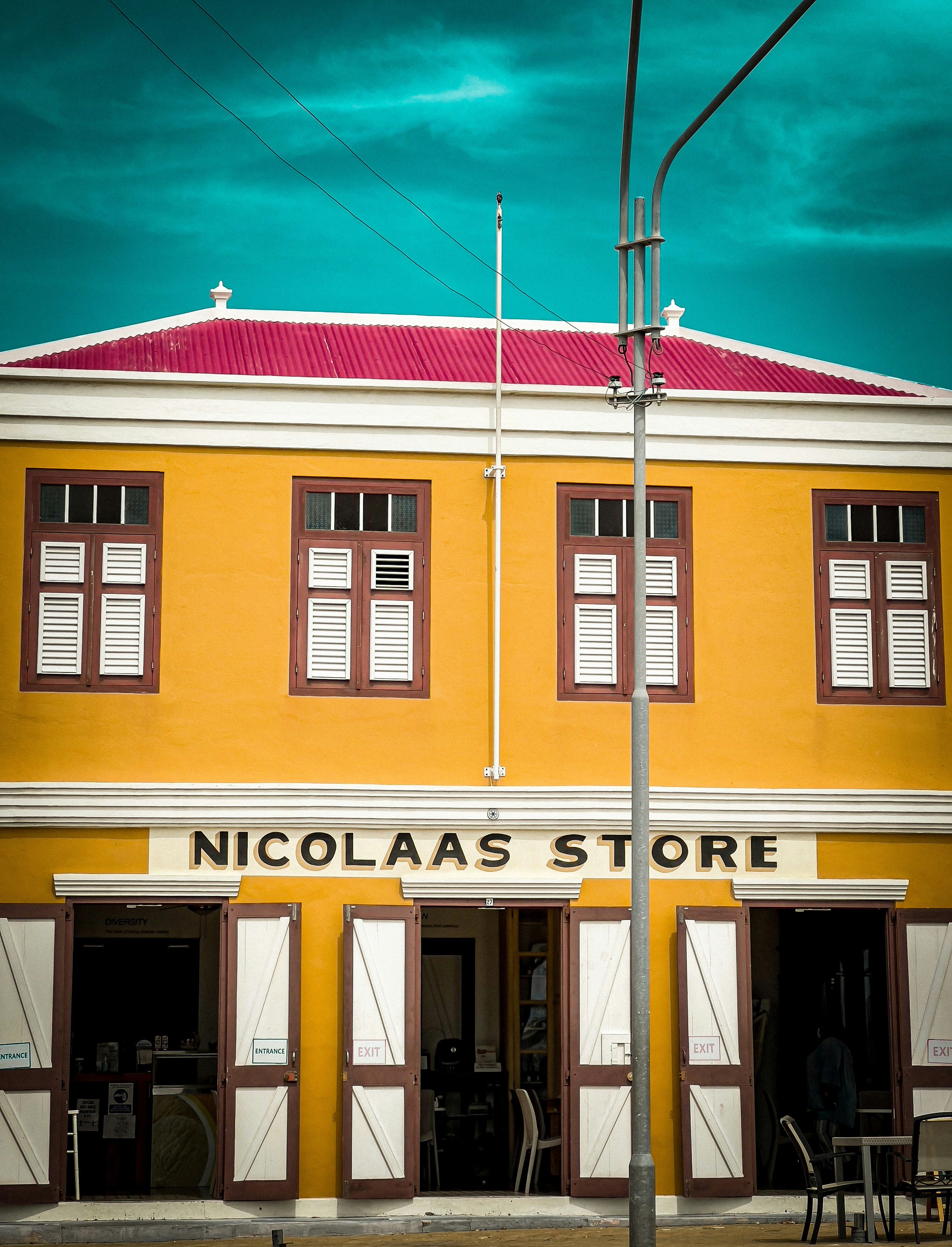 A tall yellow building with a red roof photo – Free Home decor Image on ...
