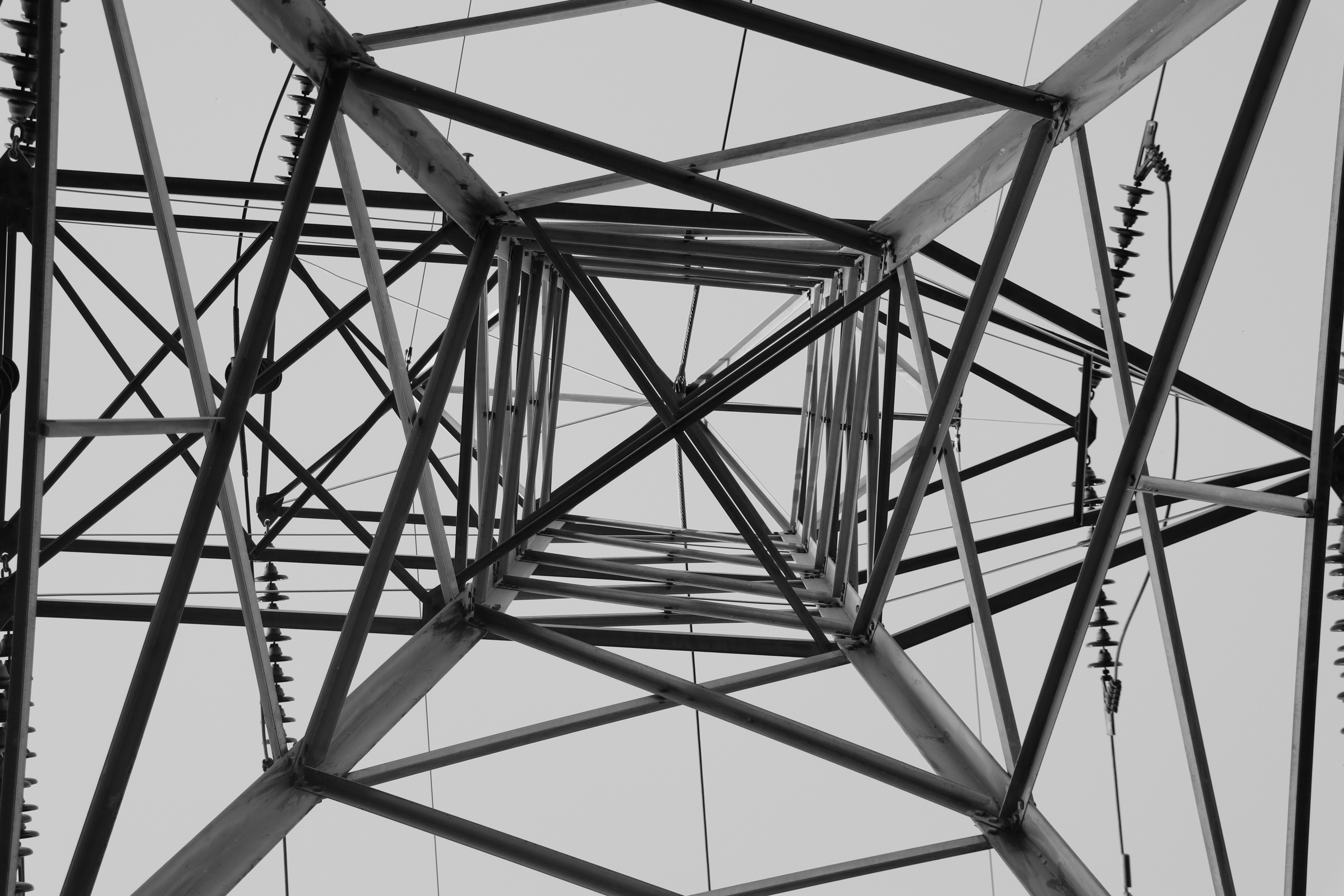 a black and white photo of an electrical tower