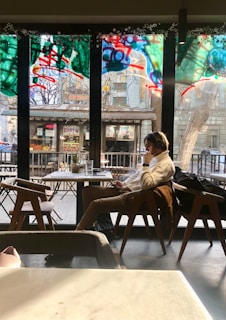 a person sitting in a chair in front of a window