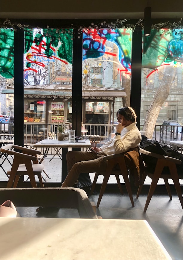 a person sitting in a chair in front of a window