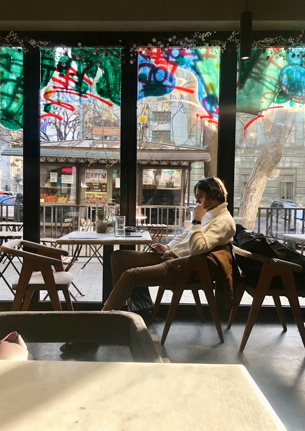 a person sitting in a chair in front of a window