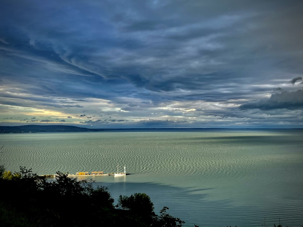 a large body of water under a cloudy sky