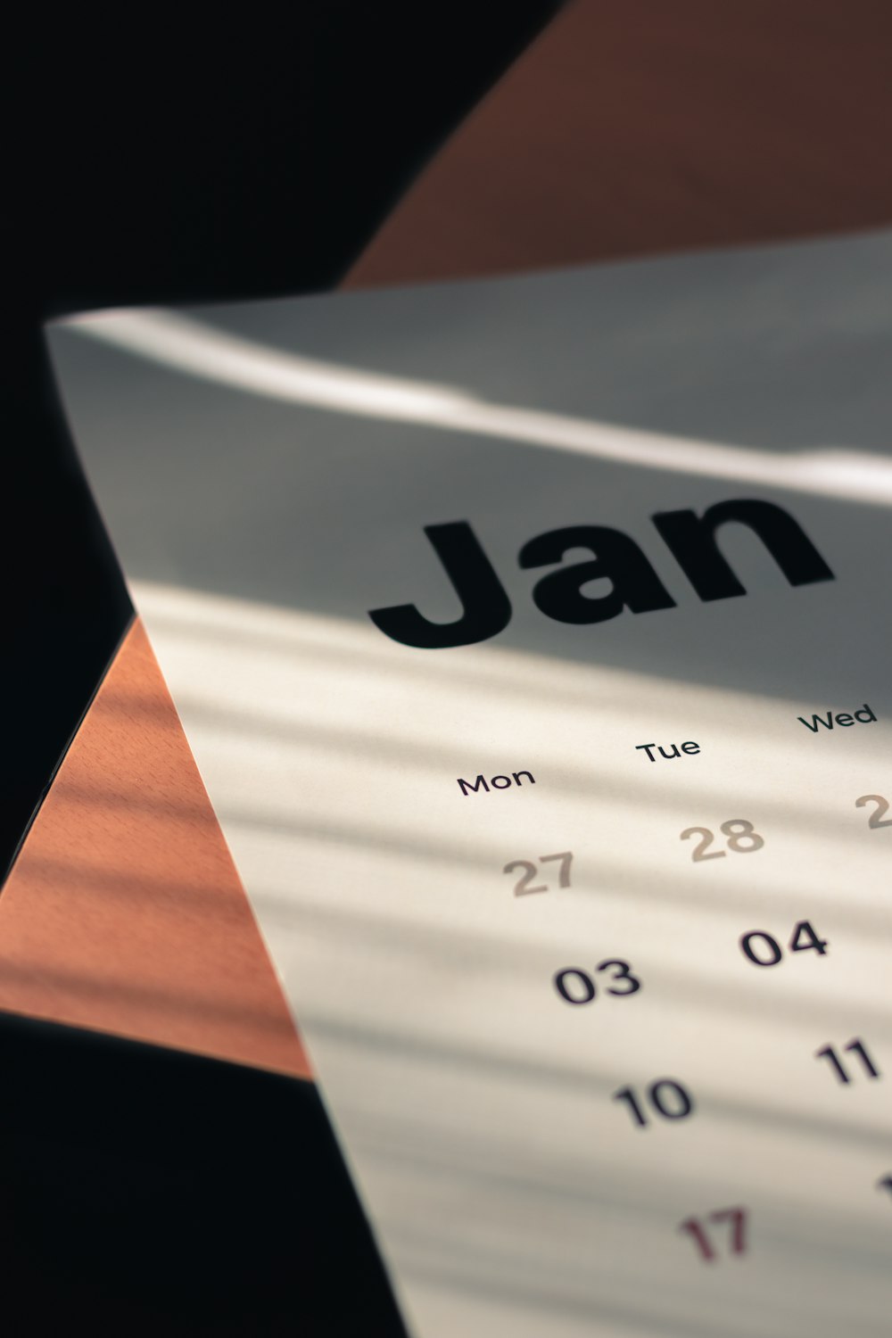 a calendar sitting on top of a wooden table