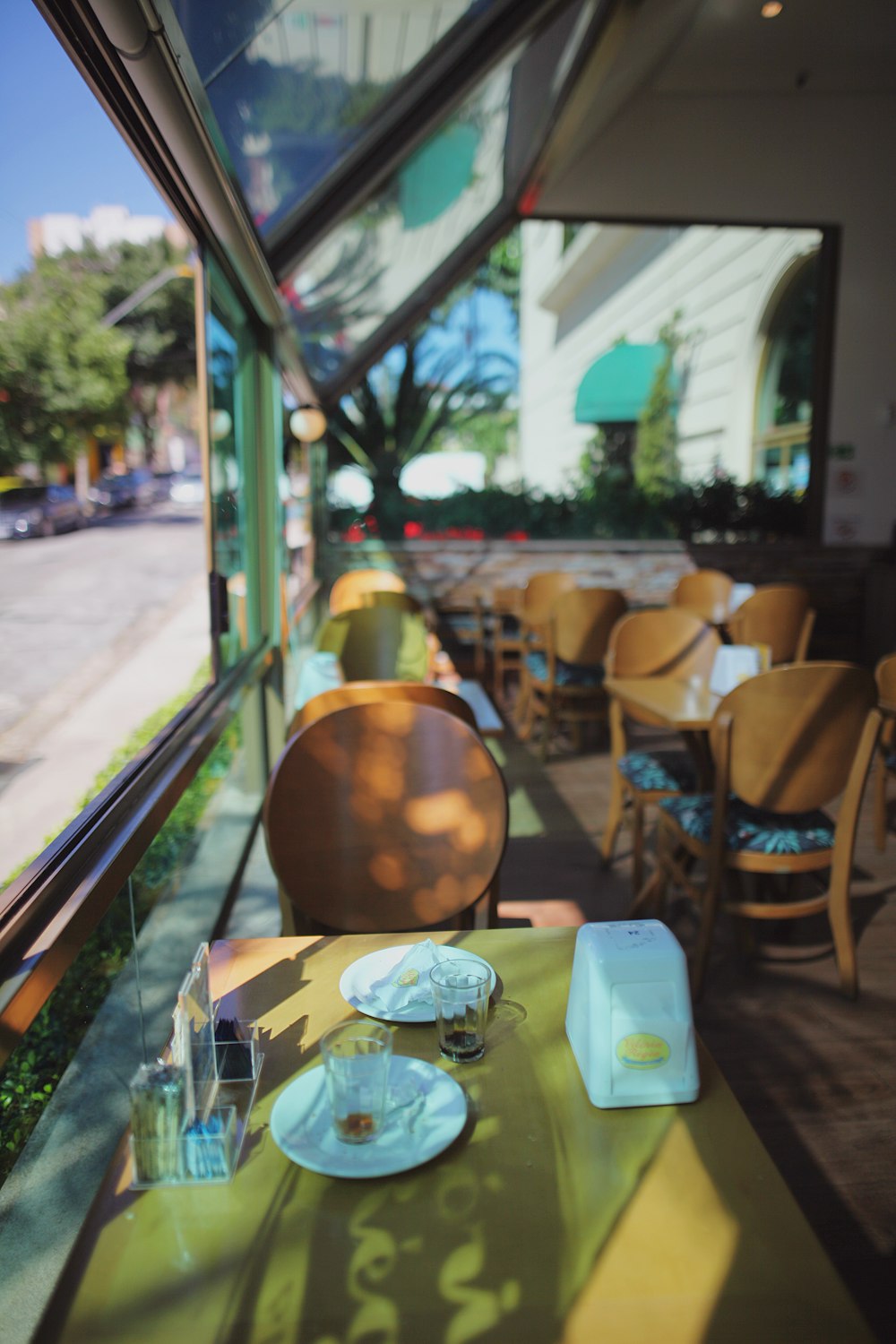 a table with a plate of food on it in front of a window