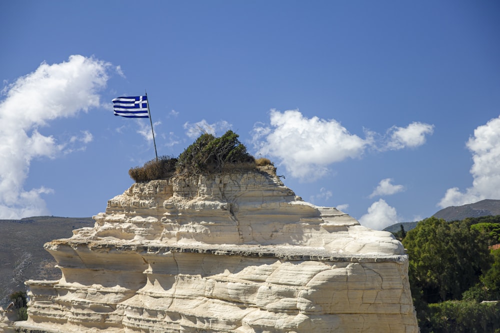 a flag flying on top of a rocky outcropping