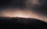 A moody, artistic illustration of a mysterious, shadowed forest at twilight.