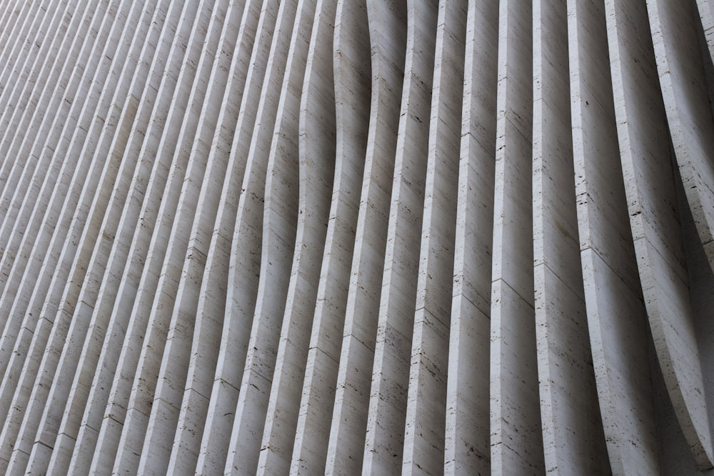 a close up of a white wall with vertical lines