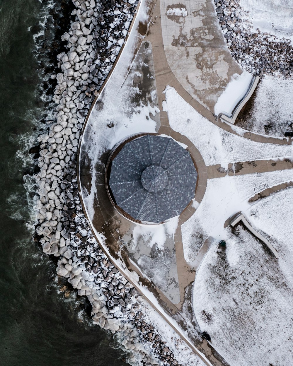 an aerial view of a circular structure in the snow