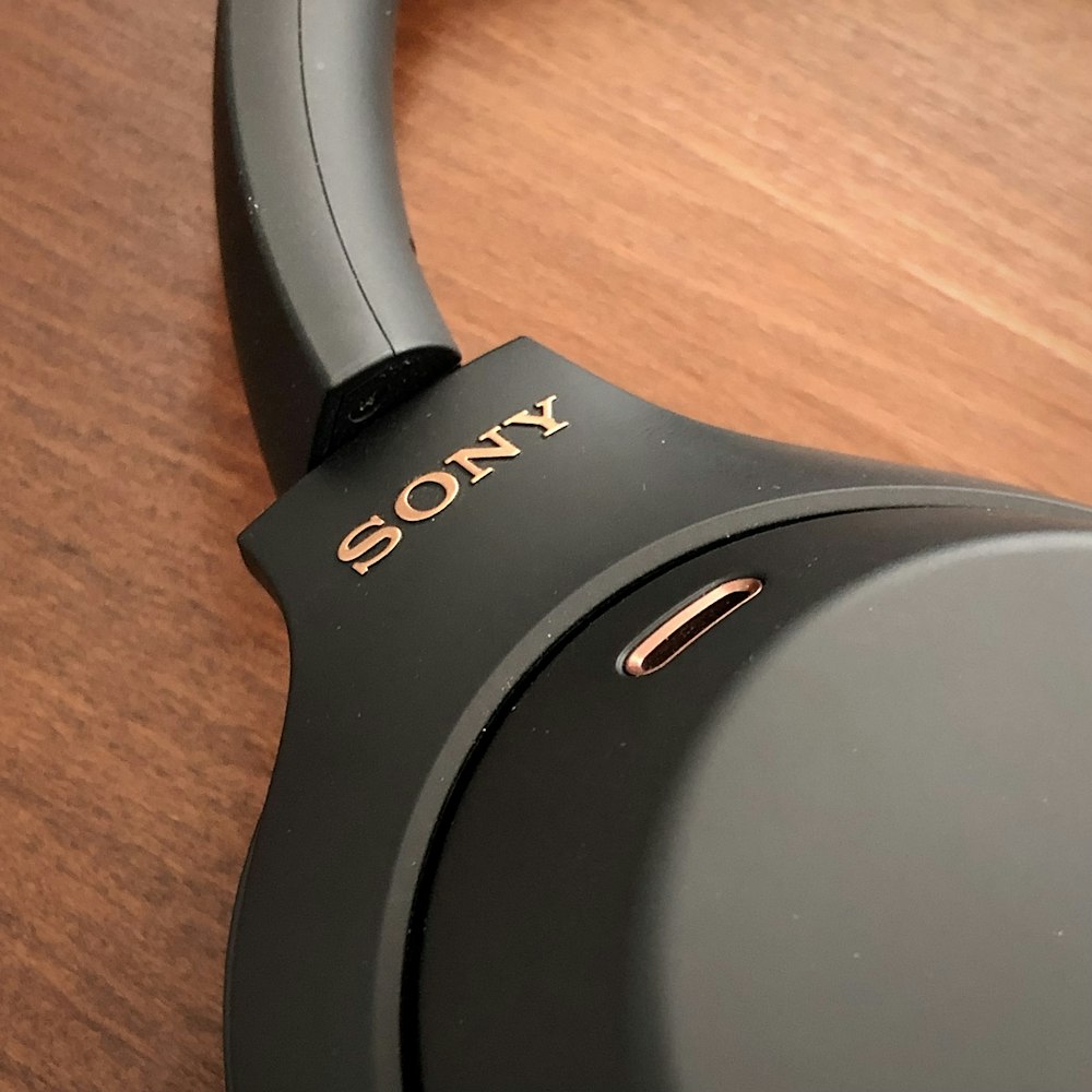a sony headphone sitting on top of a wooden table