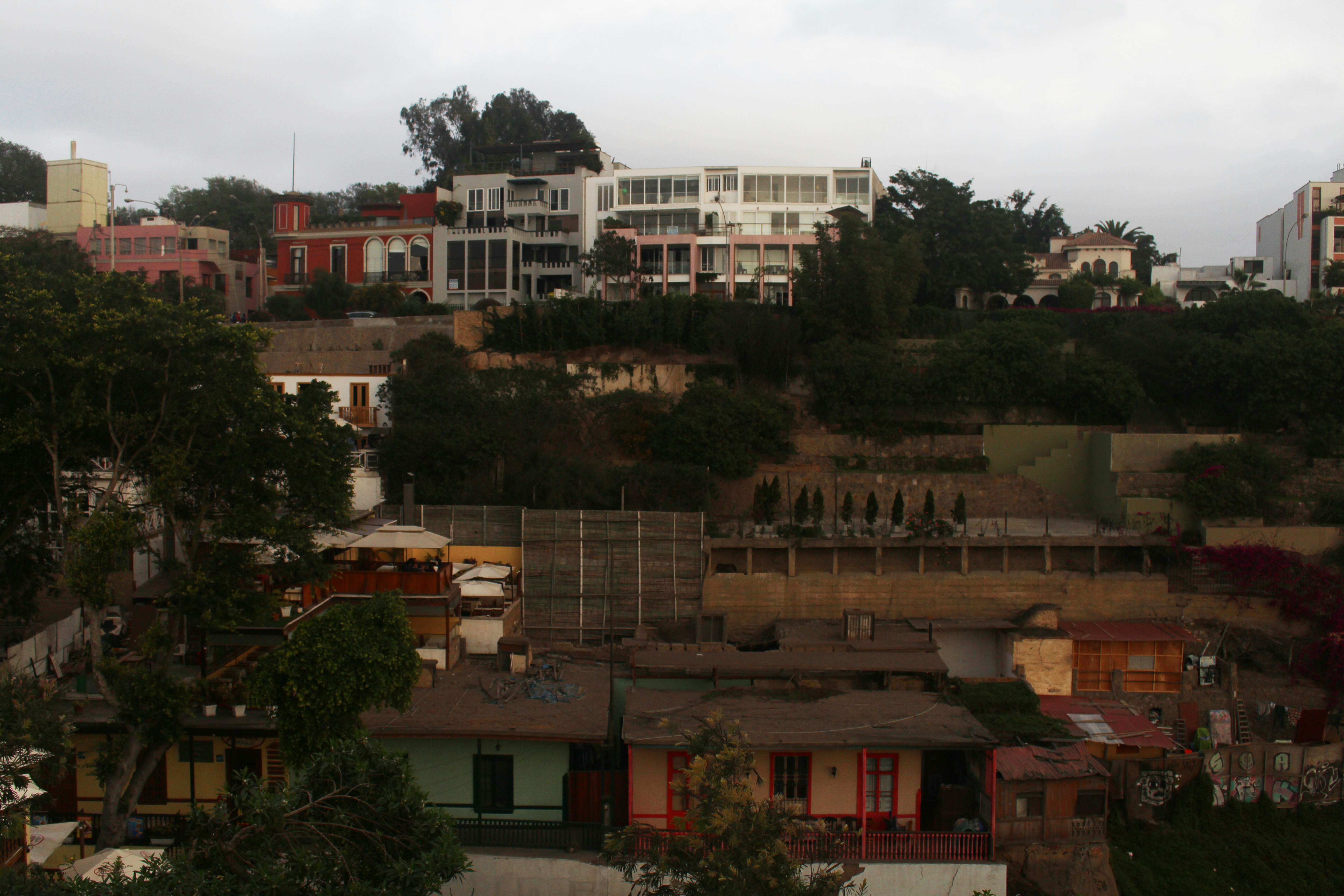 a city with lots of houses on top of a hill
