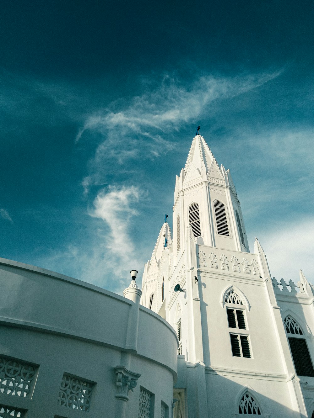 a large white building with a clock on it's side