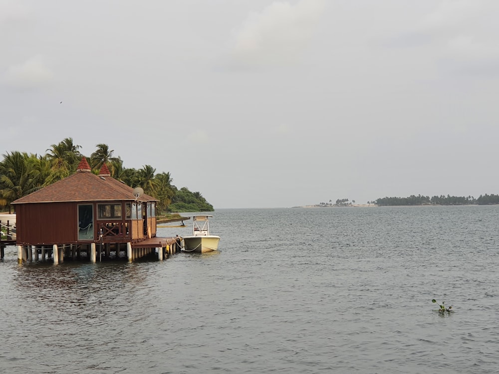 a house on a dock in the middle of the ocean